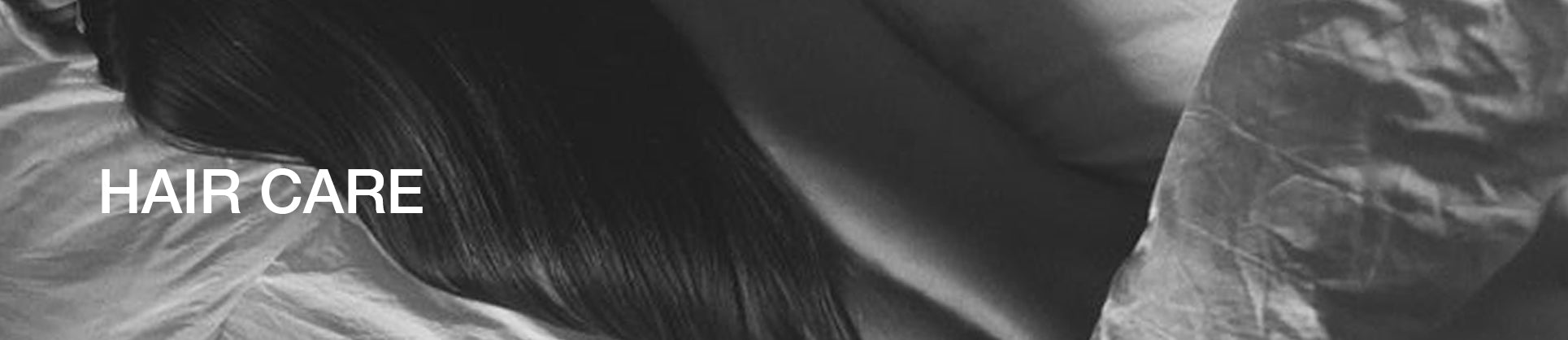 Black & White picture Wavy hair Hair Care written on it