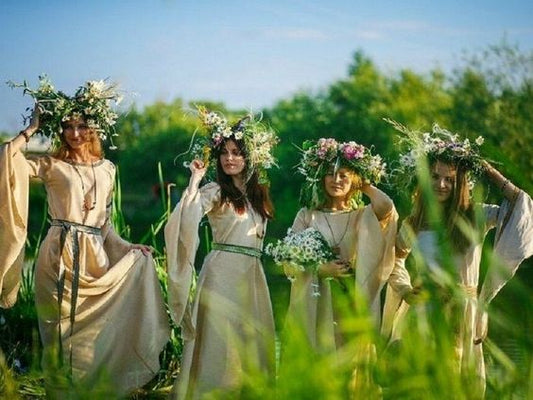 Four womens dressed up wearing crown of flowers 