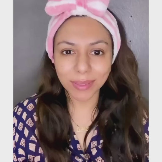 Video showcasing women showing and applying the oil texture on her scalp with a help of a dropper then gently  massaging her head with her hands , smilling women